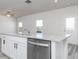 Kitchen island with granite countertop, stainless steel dishwasher, and modern faucet fixture at 481 Prescott Way, Villa Rica, GA 30180