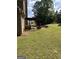 Spacious backyard with grass and a stone patio with a pergola at 121 Fountain Oak, Villa Rica, GA 30180