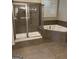 Bathroom featuring a glass shower, a tiled bathtub, and window at 121 Fountain Oak, Villa Rica, GA 30180