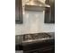 Sleek cooktop with modern vent hood and black cabinets at 121 Fountain Oak, Villa Rica, GA 30180