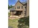 Two story home featuring a patio, stone and wood columns, and large backyard at 121 Fountain Oak, Villa Rica, GA 30180