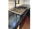 A kitchen sink with a modern faucet and dark countertops at 121 Fountain Oak, Villa Rica, GA 30180