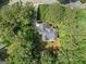 Aerial view showcasing the home's location with its surrounding trees and a long driveway at 120 Oak Shadow Way, Fayetteville, GA 30215