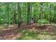 The cozy outbuilding adds a touch of rustic charm to the property's wooded backyard at 120 Oak Shadow Way, Fayetteville, GA 30215