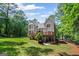 This home includes a spacious backyard with a deck, patio, and well-maintained landscaping at 120 Oak Shadow Way, Fayetteville, GA 30215