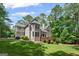 A sprawling backyard, showcasing the home's unique architectural details and outdoor living space at 120 Oak Shadow Way, Fayetteville, GA 30215