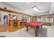 Finished basement with a bar, stone accents, wood floors, and pool table at 120 Oak Shadow Way, Fayetteville, GA 30215