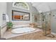 Luxurious bathroom with a large soaking tub, walk-in shower, and unique mirrors at 120 Oak Shadow Way, Fayetteville, GA 30215