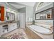 Luxurious bathroom with a large soaking tub, double vanity, and neutral tile at 120 Oak Shadow Way, Fayetteville, GA 30215