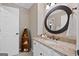 Cozy bathroom with granite countertop, boat-shaped shelving, decorative mirror, and soft, neutral tones at 120 Oak Shadow Way, Fayetteville, GA 30215