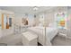 Well-lit bedroom with beach-inspired decor, showcasing a white iron bed frame and ample natural light at 120 Oak Shadow Way, Fayetteville, GA 30215