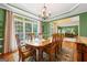 Dining room featuring a table set for six, hardwood floors, and a large window at 120 Oak Shadow Way, Fayetteville, GA 30215