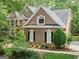 Brick house featuring clean architectural lines, manicured shrubbery and a paved driveway at 120 Oak Shadow Way, Fayetteville, GA 30215