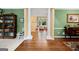 Open foyer showcasing hardwood flooring, decorative columns, and a glimpse into the living room at 120 Oak Shadow Way, Fayetteville, GA 30215