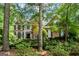 Traditional brick home featuring dark shutters, manicured landscaping and mature trees on a sunny day at 120 Oak Shadow Way, Fayetteville, GA 30215