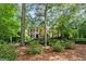 Charming brick home surrounded by mature trees and lush landscaping at 120 Oak Shadow Way, Fayetteville, GA 30215