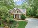 Traditional brick home with meticulously manicured landscaping and a long driveway at 120 Oak Shadow Way, Fayetteville, GA 30215