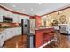 Open-concept kitchen with breakfast bar, stainless steel appliances, and hardwood floors at 120 Oak Shadow Way, Fayetteville, GA 30215