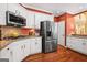 Updated kitchen with stainless steel appliances, white cabinets, and granite countertops at 120 Oak Shadow Way, Fayetteville, GA 30215