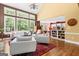 Bright, open-concept living area featuring a wall of windows and connected kitchen with bar seating at 120 Oak Shadow Way, Fayetteville, GA 30215