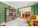 Cozy sitting area featuring a bookcase, hardwood floors, and an open view into the dining room at 120 Oak Shadow Way, Fayetteville, GA 30215