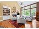 Inviting living room with stone fireplace, built-in shelving, hardwood flooring, and a high ceiling at 120 Oak Shadow Way, Fayetteville, GA 30215