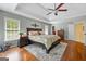 This main bedroom features a tray ceiling, hardwood floors, and a ceiling fan at 120 Oak Shadow Way, Fayetteville, GA 30215