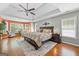 Spacious main bedroom features tray ceiling, hardwood floors, and large windows at 120 Oak Shadow Way, Fayetteville, GA 30215