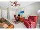 Home office featuring a desk, red chair, futon, and natural lighting at 120 Oak Shadow Way, Fayetteville, GA 30215