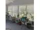 Sunroom with windows and natural light, filled with plants and comfortable furniture for relaxation at 3705 Sandhill Se Dr, Conyers, GA 30094
