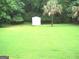 Large backyard with an outbuilding and mature trees, offering a private and serene setting at 225 Long Creek Dr, Covington, GA 30016