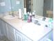 This bathroom features a double sink, a mirror, and tile floors at 225 Long Creek Dr, Covington, GA 30016