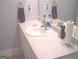 A clean bathroom with a vanity featuring a white sink and mirror at 225 Long Creek Dr, Covington, GA 30016
