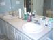 Bathroom featuring double sinks with white cabinets and ample counter space at 225 Long Creek Dr, Covington, GA 30016