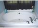 A pristine white bathtub with chrome fixtures and black curtain at 225 Long Creek Dr, Covington, GA 30016