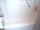 Clean and functional bathtub with white tile surround and shower curtain at 225 Long Creek Dr, Covington, GA 30016