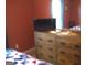 Bedroom featuring a wooden dresser and tv for comfort and convenience at 225 Long Creek Dr, Covington, GA 30016