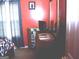 Modest bedroom with a dark wooden desk and orange walls at 225 Long Creek Dr, Covington, GA 30016