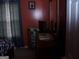 Bedroom with red walls, dark curtains, and a dresser with a TV on it at 225 Long Creek Dr, Covington, GA 30016