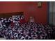 Red bedroom featuring a bed with decorative pillows and an ornate blanket at 225 Long Creek Dr, Covington, GA 30016