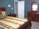Bedroom with patterned walls, wooden furniture, and patterned bedspread at 225 Long Creek Dr, Covington, GA 30016