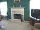 Bright living room with a fireplace and teal-colored walls at 225 Long Creek Dr, Covington, GA 30016