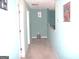Neutral-toned hallway with a light fixture and charming decor at 225 Long Creek Dr, Covington, GA 30016