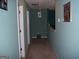 Hallway view featuring green walls and several doorways at 225 Long Creek Dr, Covington, GA 30016