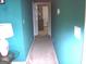 This hallway features carpeted floors, neutral paint, and leads to other rooms at 225 Long Creek Dr, Covington, GA 30016
