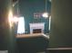 View of the living room featuring a marble fireplace, ceiling fan, and vibrant green walls at 225 Long Creek Dr, Covington, GA 30016