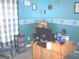 Bright office space featuring a blue accent wall and a wooden desk setup at 225 Long Creek Dr, Covington, GA 30016