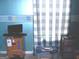 Bright office space featuring a blue accent wall and a wooden desk setup at 225 Long Creek Dr, Covington, GA 30016