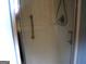 Neutral tiled shower stall featuring a grab bar and shower head fixture at 225 Long Creek Dr, Covington, GA 30016