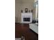 Inviting living room features a white mantle over a fireplace and hardwood floors at 85 Bermuda Run Dr, Covington, GA 30016